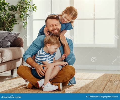 Happy Dad And Kids Embracing At Home Stock Photo Image Of Carefree